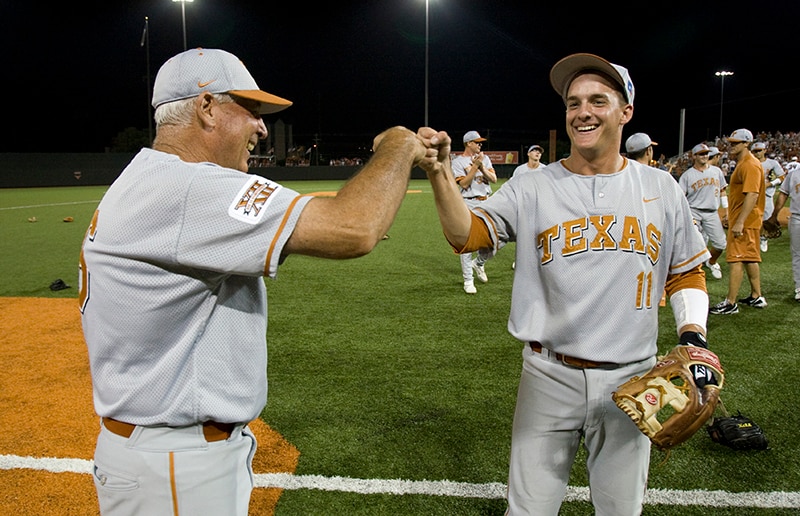 Texas' Augie Garrido fist bumps Brandon Loy after the longest college baseball game in history.