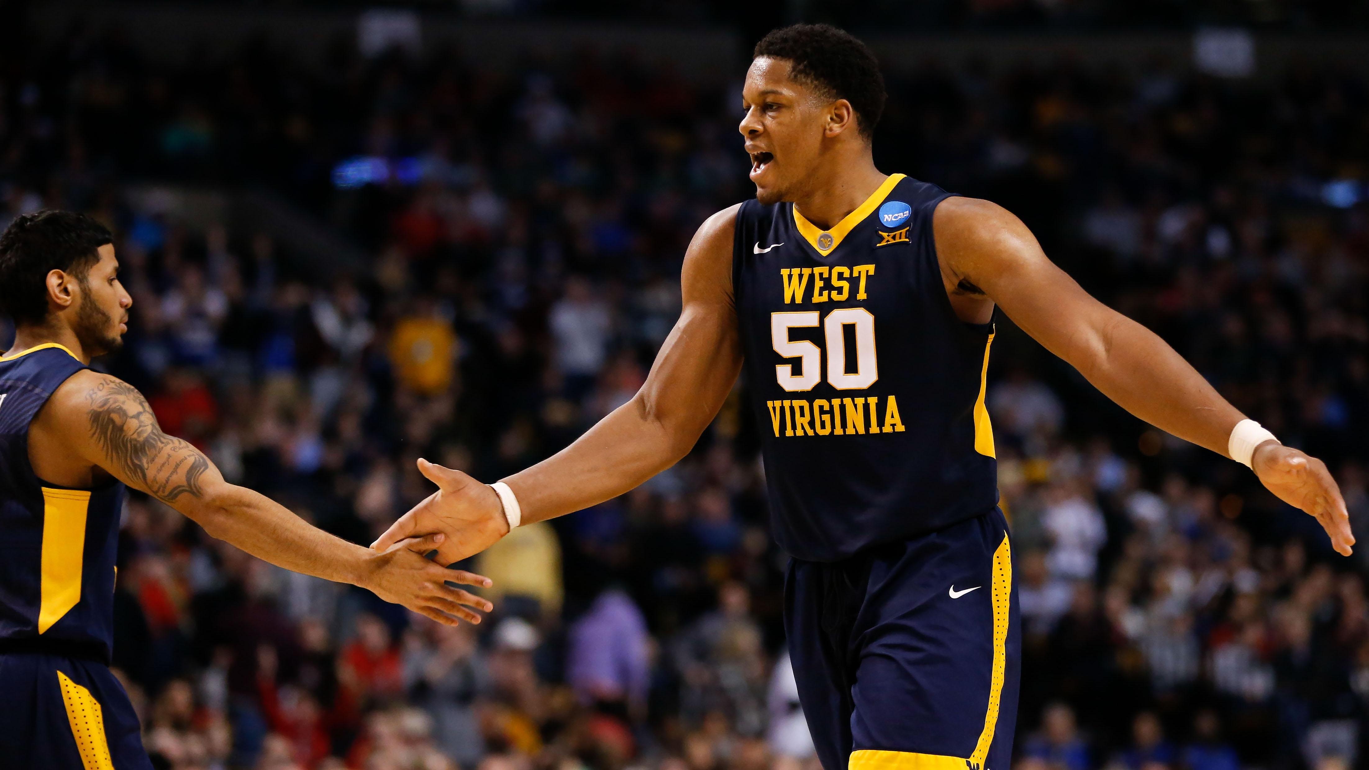 West Virginia's Sagaba Konate high fives a teammate