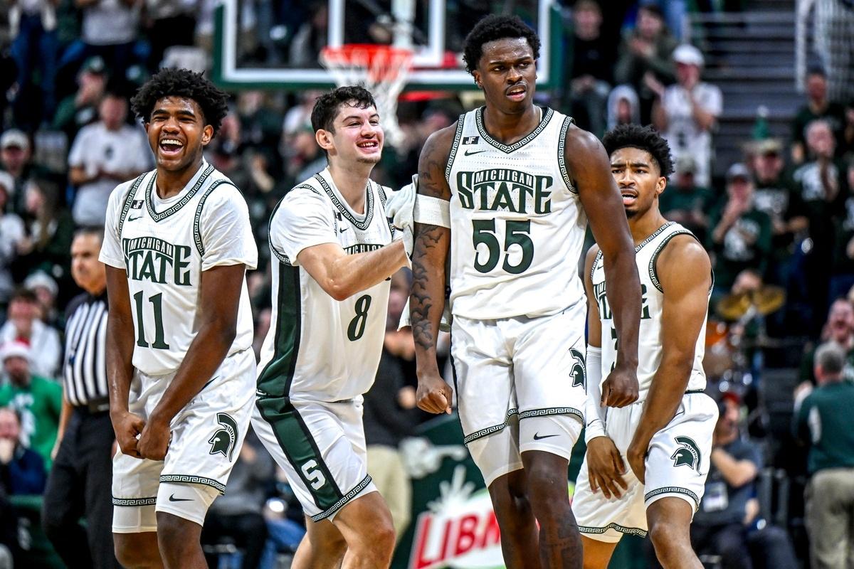 Michigan State's Coen Carr, center, celebrates with, from left, Jase Richardson, Frankie Fidler and Jaden Akins after Carr's three-pointer