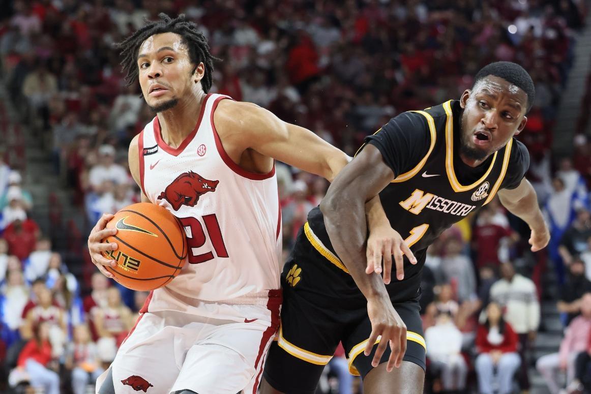 Arkansas Razorbacks guard D.J. Wagner (21) drives against Missouri Tigers guard Marques Warrick (1) during the first half at Bud Walton Arena. 